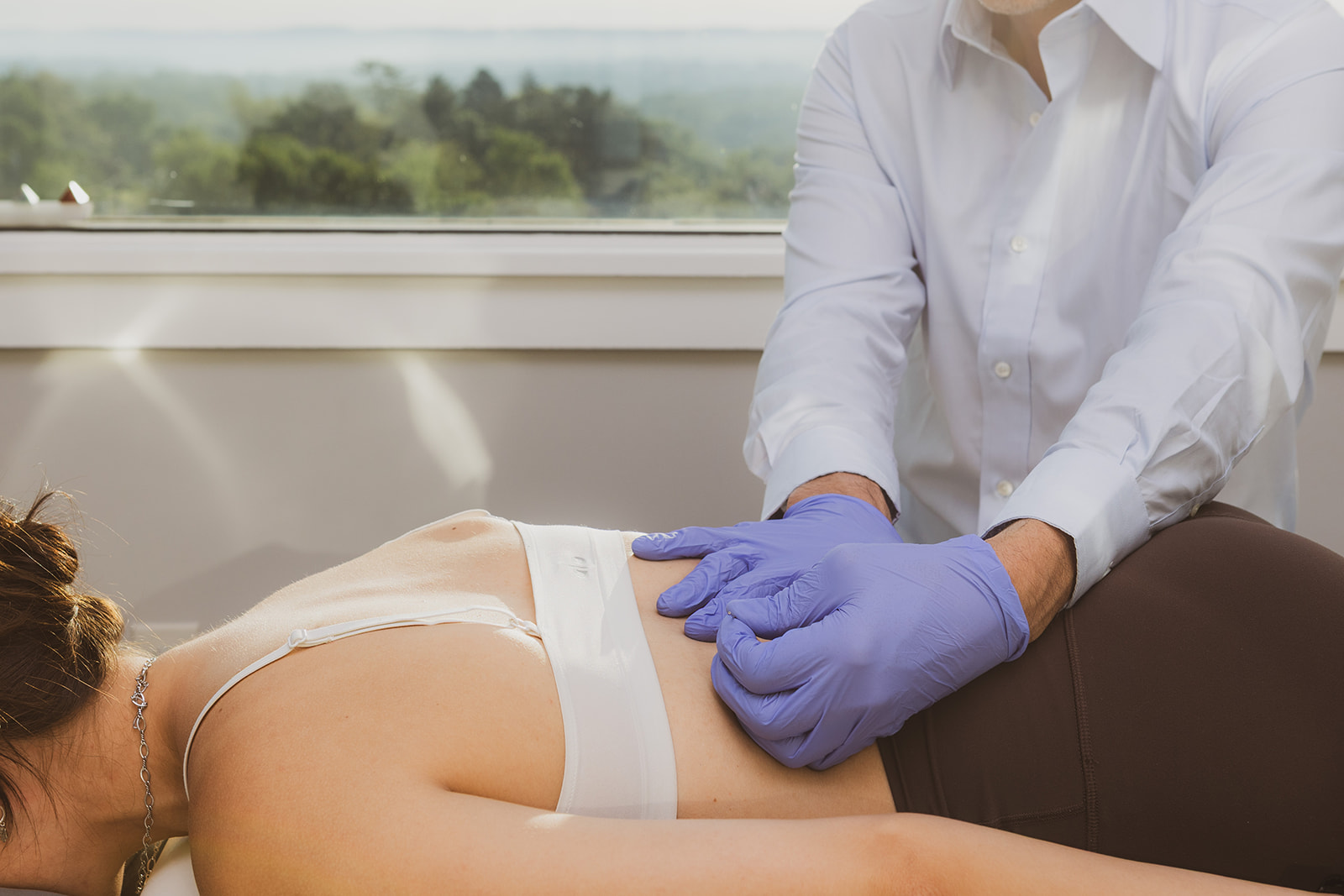Dr. Rob Satriano treating a patient with dry needling for low back pain