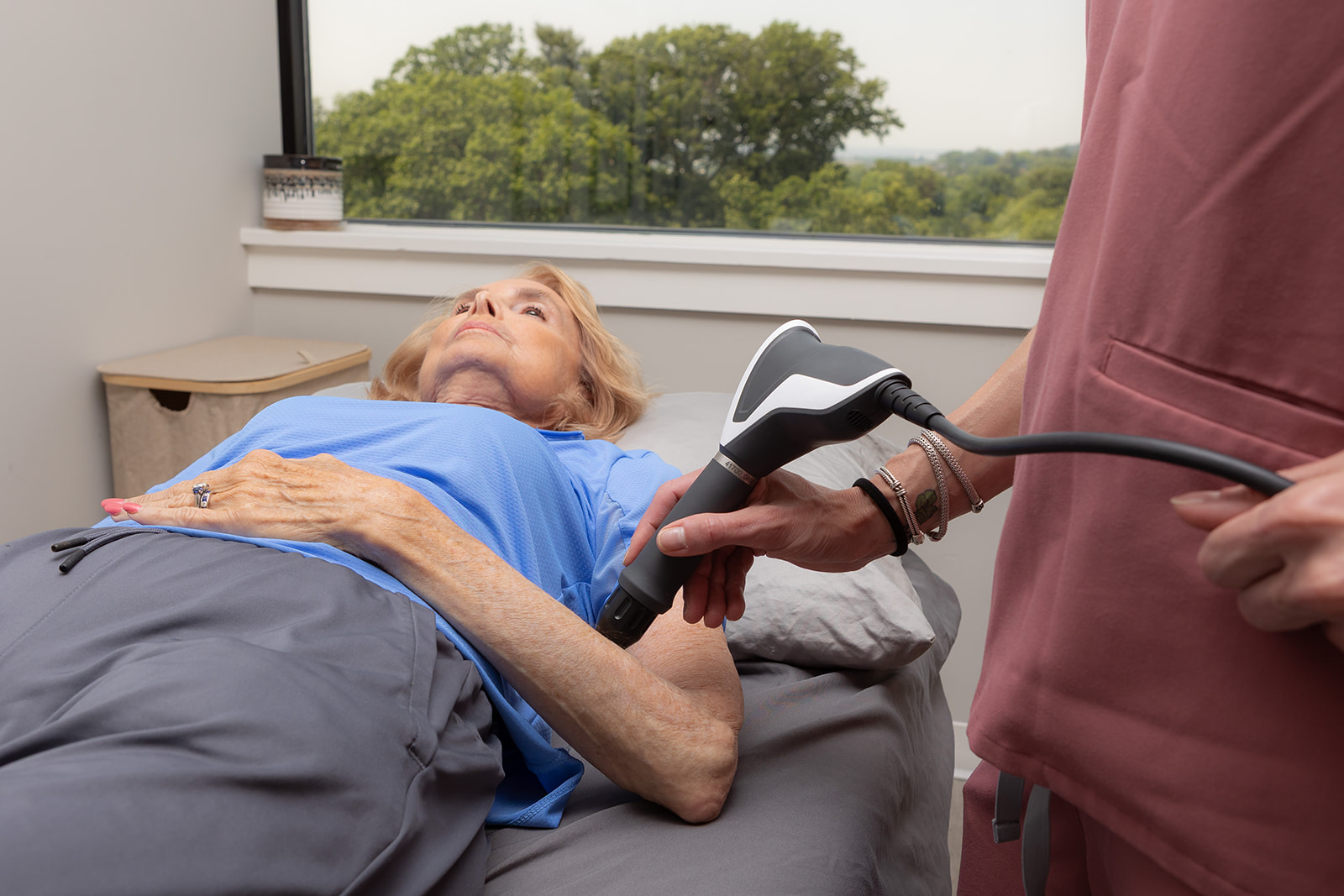 Therapist treating a patient lying on a table