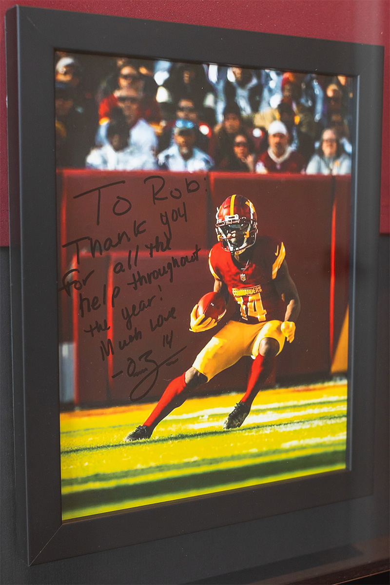 Framed sports photograph featuring an American football player in action